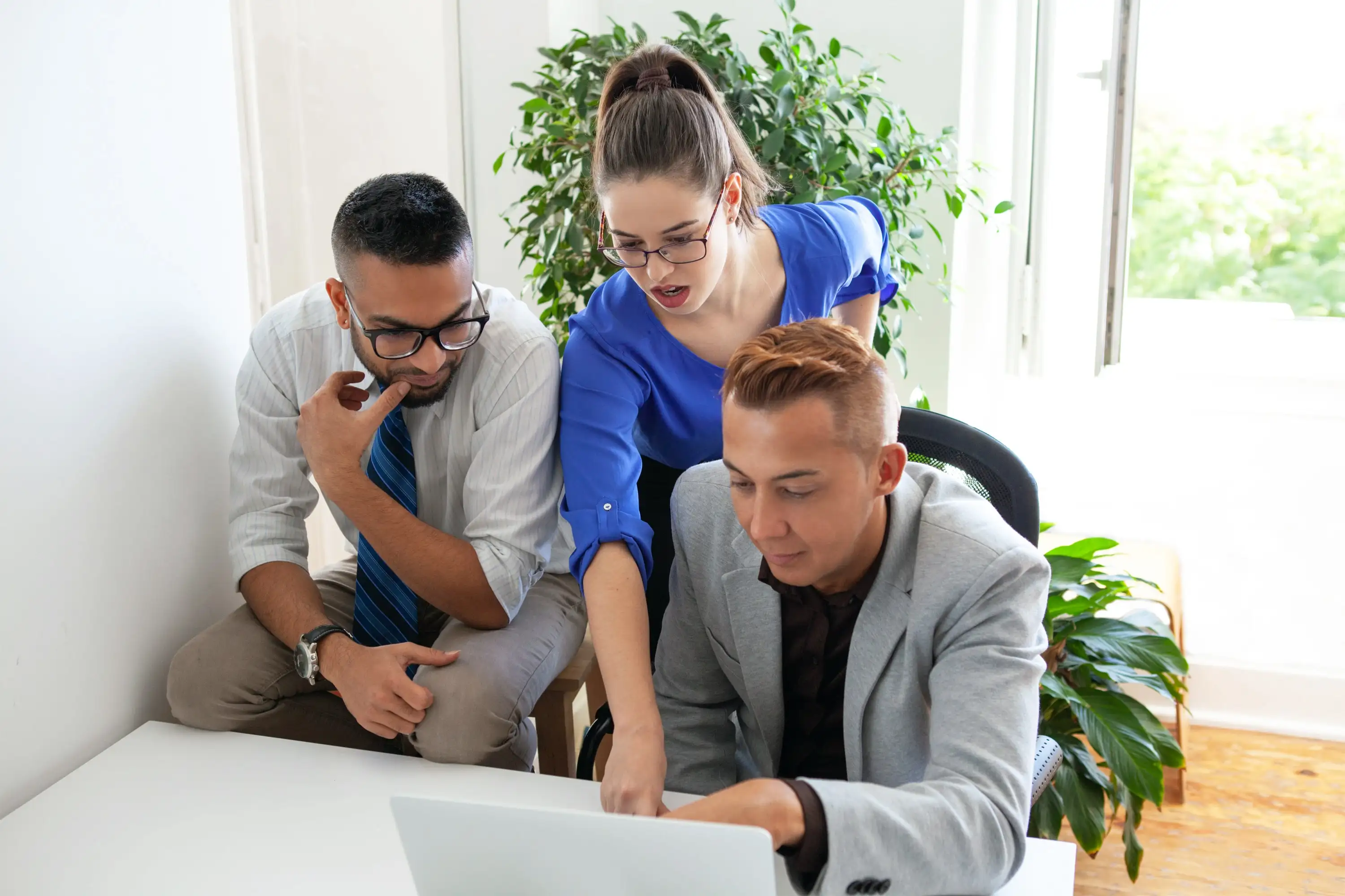 Enthusiastic team happily brainstorming in a software company