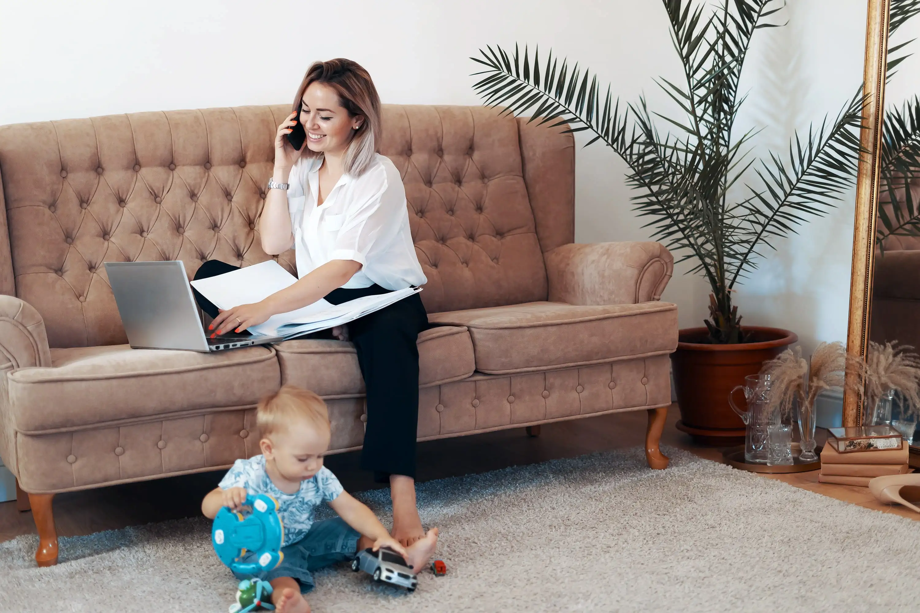 Work-life balance: Mom working remotely with child